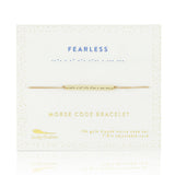 Lucky Feather Fearless Morse Code Bracelet on card featuring a gold-dipped bar engraved with 'Fearless' in Morse code, on an adjustable cord. Available at Be Charmed.