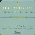 Lucky Feather Fun Twenty-One Milestone Birthday Bracelet on card featuring 21 gold-dipped beads on an adjustable cord, symbolizing each year. Available at Be Charmed.