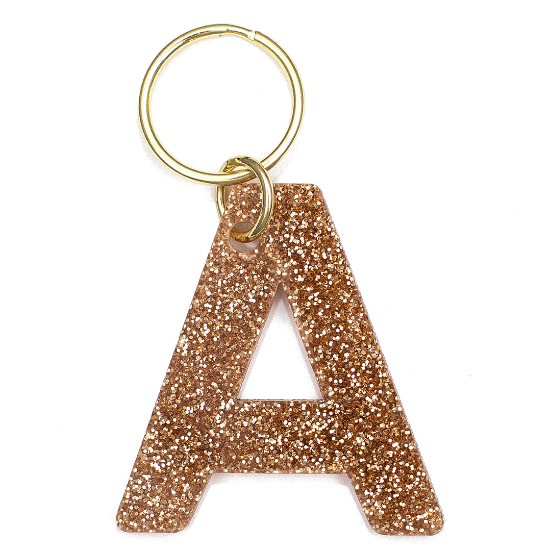Lucky Feather Initial A Keychain featuring glittery acrylic letter charm with gold-tone hardware, personalized for each letter. Available at Be Charmed.