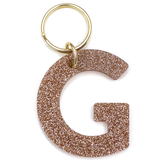Lucky Feather Initial G Keychain featuring glittery acrylic letter charm with gold-tone hardware, personalized for each letter. Available at Be Charmed.