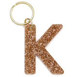 Lucky Feather Initial K Keychain featuring glittery acrylic letter charm with gold-tone hardware, personalized for each letter. Available at Be Charmed.