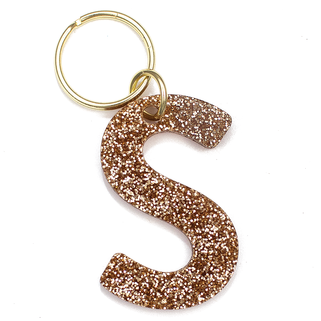 Lucky Feather Initial S Keychain featuring glittery acrylic letter charm with gold-tone hardware, personalized for each letter. Available at Be Charmed.