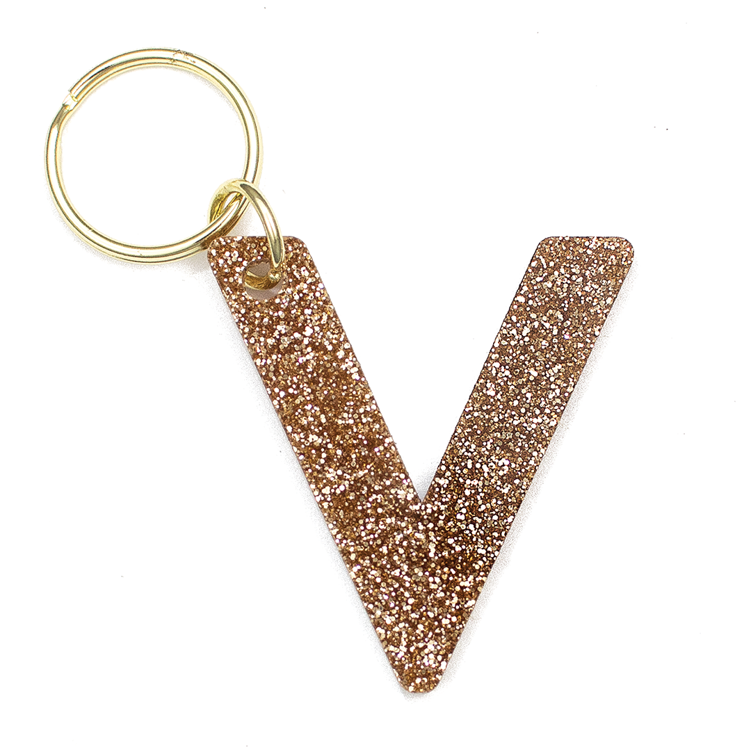 Lucky Feather Initial V Keychain featuring glittery acrylic letter charm with gold-tone hardware, personalized for each letter. Available at Be Charmed.
