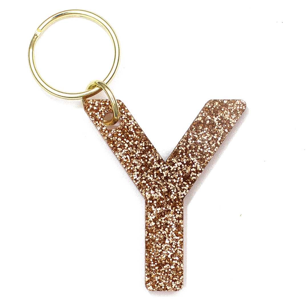 Lucky Feather Initial Y Keychain featuring glittery acrylic letter charm with gold-tone hardware, personalized for each letter. Available at Be Charmed.