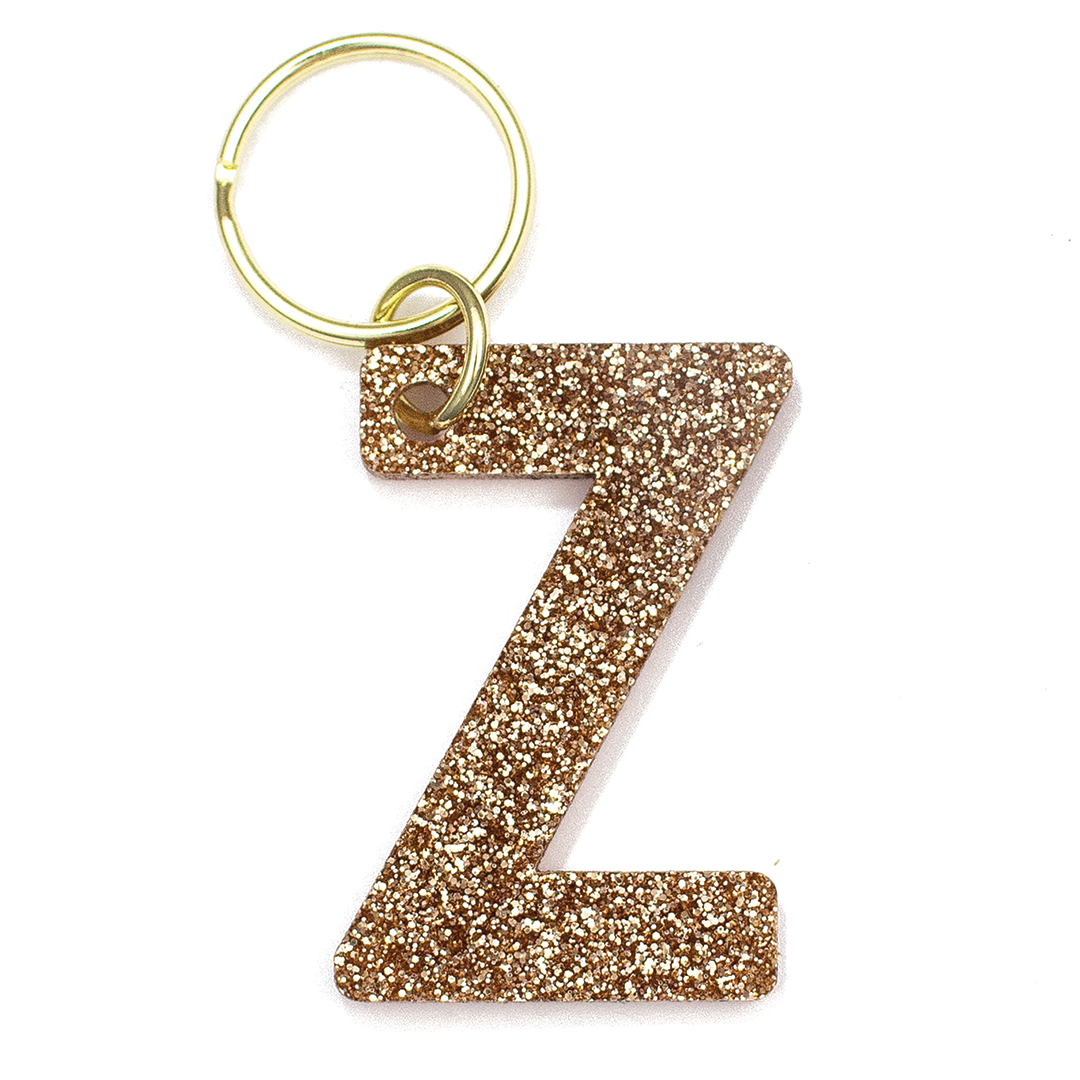 Lucky Feather Initial Z Keychain featuring glittery acrylic letter charm with gold-tone hardware, personalized for each letter. Available at Be Charmed.