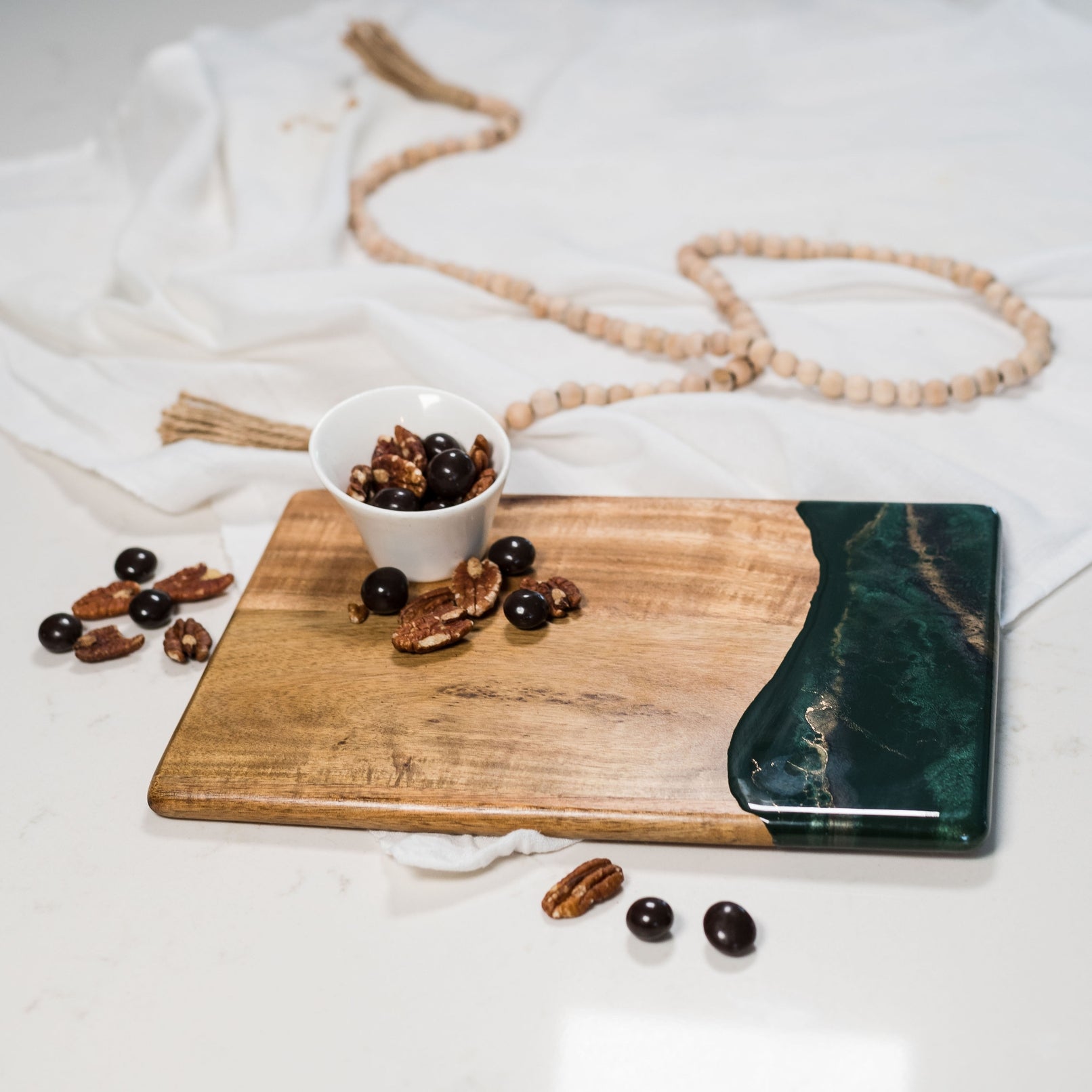 Lynn & Liana 8x11 Small Breadboard in Jade—handcrafted wood and resin board, perfect for serving or gifting. Available at Be Charmed.