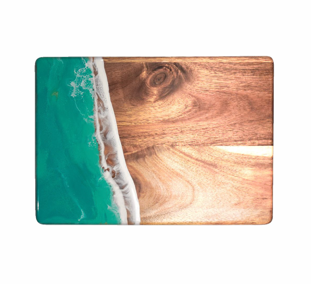 Wooden cutting board with ocean design on a white background. Available at Be Charmed