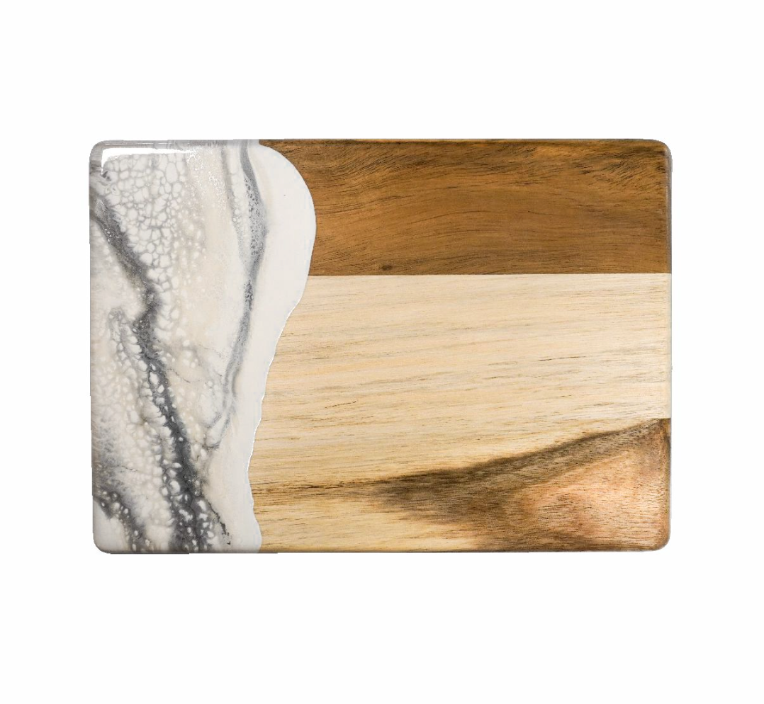 Wooden cutting board with marble pattern on a white background. Available at Be Charmed