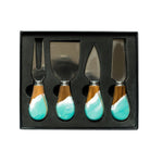 Set of four cheese knives with turquoise handles in a black box on a white background. Available at Be Charmed