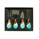 Set of four cheese knives with turquoise handles in a black box on a white background. Available at Be Charmed