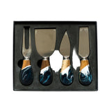 Set of four cheese knives with decorative handles in a black box on a white background. Available at Be Charmed