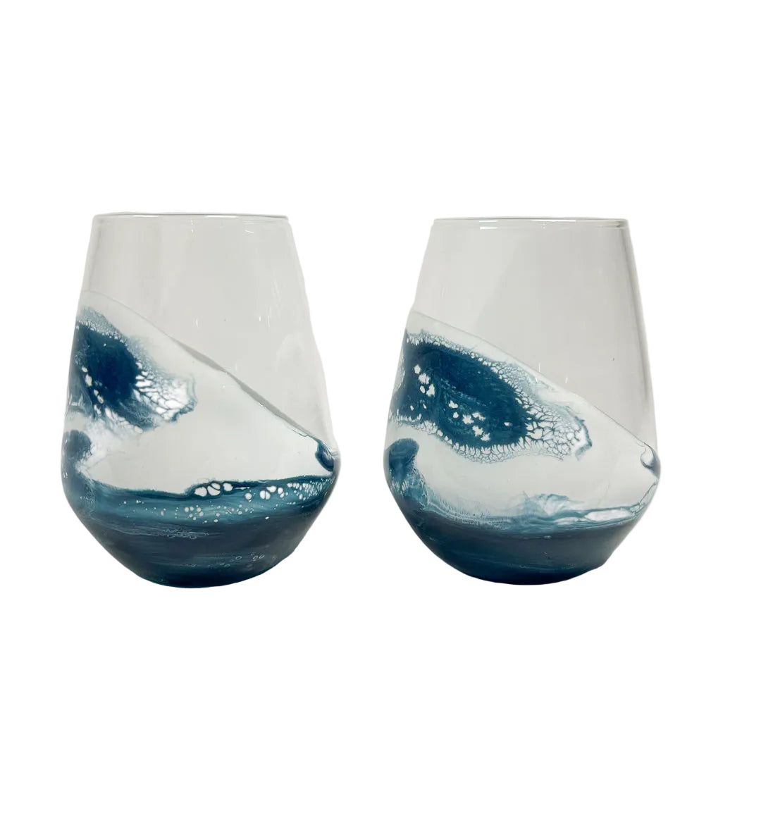 Two blue and white resin stemless wine glasses on a white background. Be Charmed