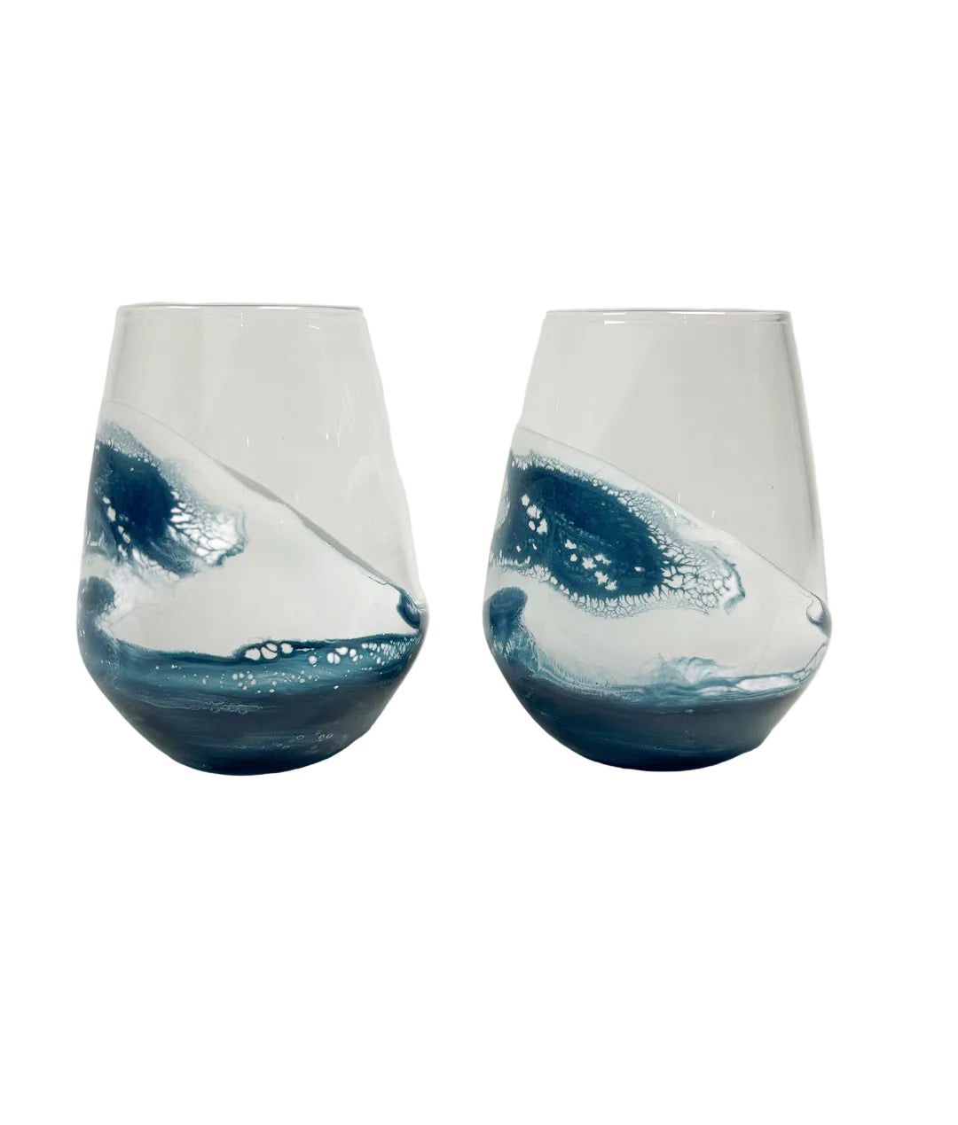 Two blue and white resin stemless wine glasses on a white background. Be Charmed
