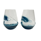 Two blue and white resin stemless wine glasses on a white background. Be Charmed