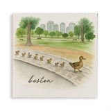 Rustic Marlin magnet with Illustration of ducks on a log with a park and city skyline in the background, labeled 'Boston'. Available at Be Charmed