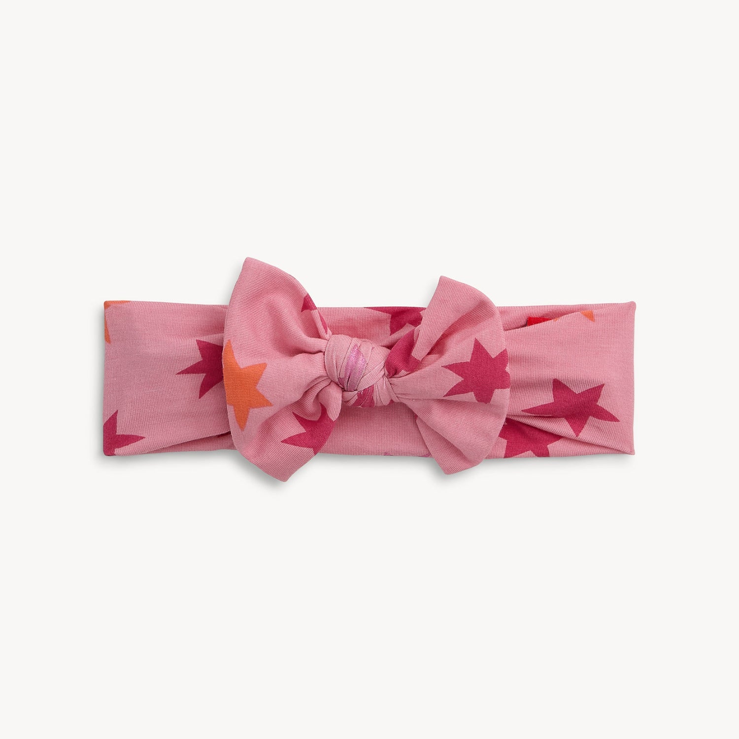 Magnetic Me Cosmic Confetti Pink headband with star pattern on a white background. Available at Be Charmed