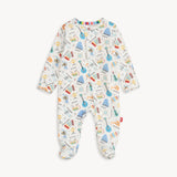 Magnetic Me Footie in Bach & Roll – ultra-soft baby footie with magnetic closures for easy changes, featuring a playful musical print, made with eco-friendly modal fabric, available at Be Charmed.
