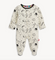 Magnetic Me baby footie in Natural Game Day print with sports icons. Soft modal fabric with magnetic closures for easy dressing. Available at Be Charmed.