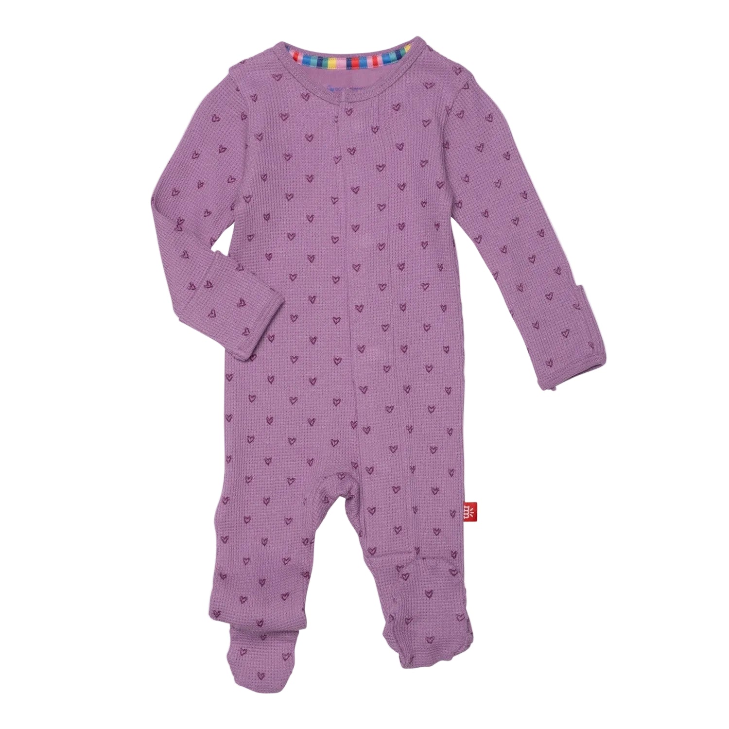 A purple magnetic me footie with a pink ribbon design and a multi-colored heart pattern on the sleeves. Available at Be Charmed
