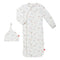 A white magnetic me baby gown with a pattern of cars and trucks, accompanied by a matching hat, both with magnets for easy dressing. Available at Be Charmed