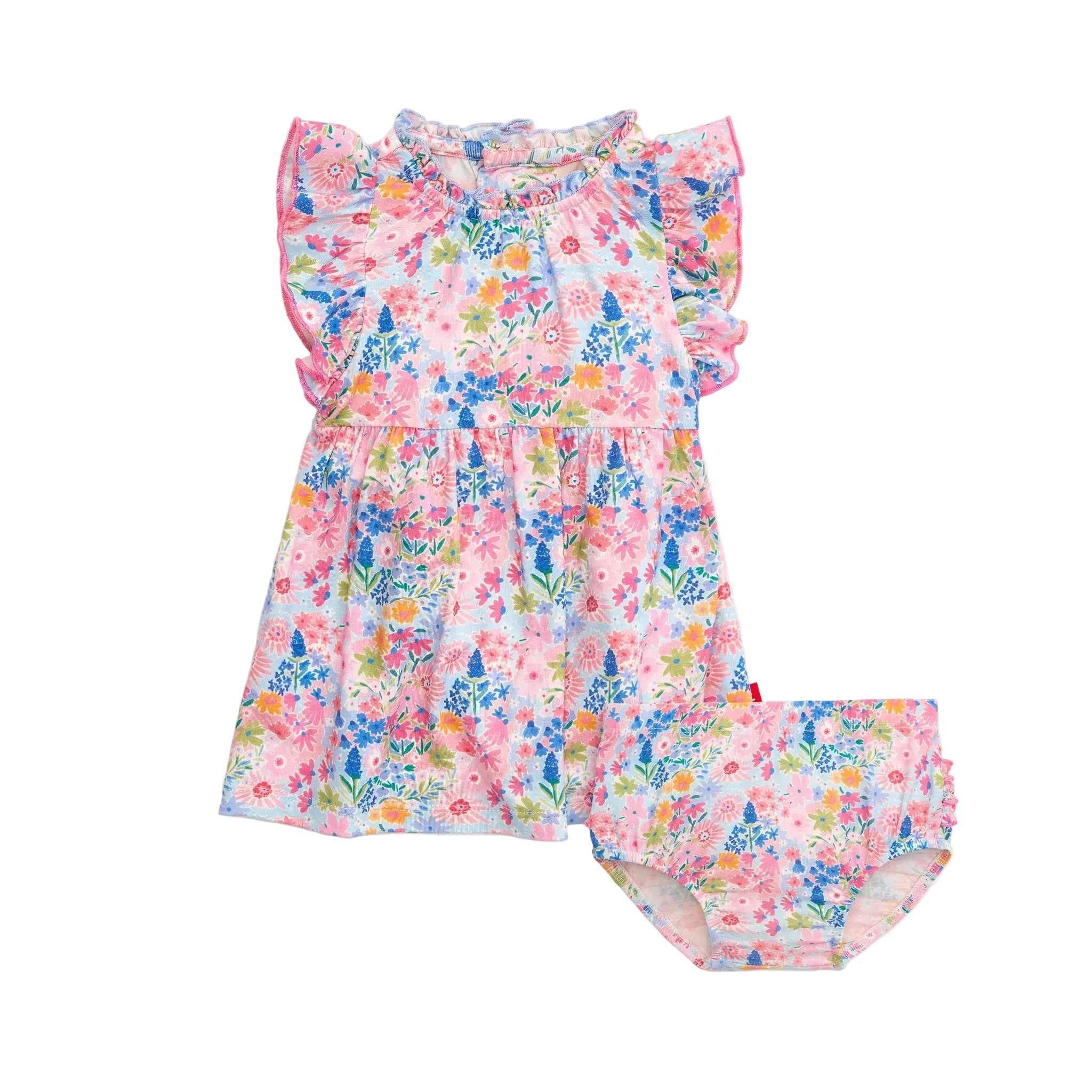 A Lily Magnetic Me baby dress and diaper cover set with floral patterns and magnetic closures. Available at Be Charmed