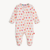 Magnetic Me Baby footie with heart pattern on a white background. Be Charmed