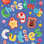 Book cover of 'Christmas Cuties' with colorful Christmas-themed illustrations on a blue background. Available at Be Charmed