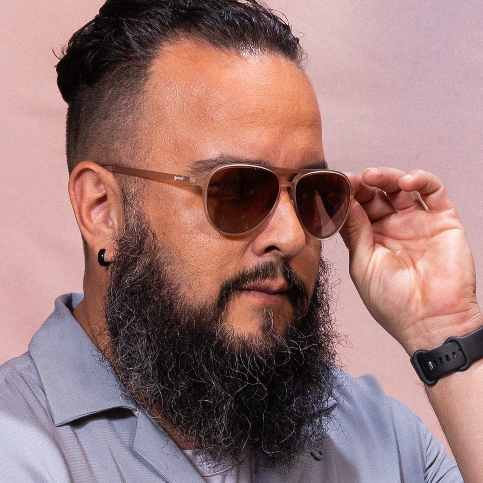 Man wearing Goodr Purple's Midlife Crisis sunglasses with polarized lenses and lightweight no-slip frame stylish fun sunglasses for outdoor adventures Available at Be Charmed