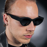 Man Wearing Goodr In My Cosmic Era sunglasses with galaxy-inspired frames, mirrored polarized lenses, and no-slip fit—perfect for bold, active style at Be Charmed.