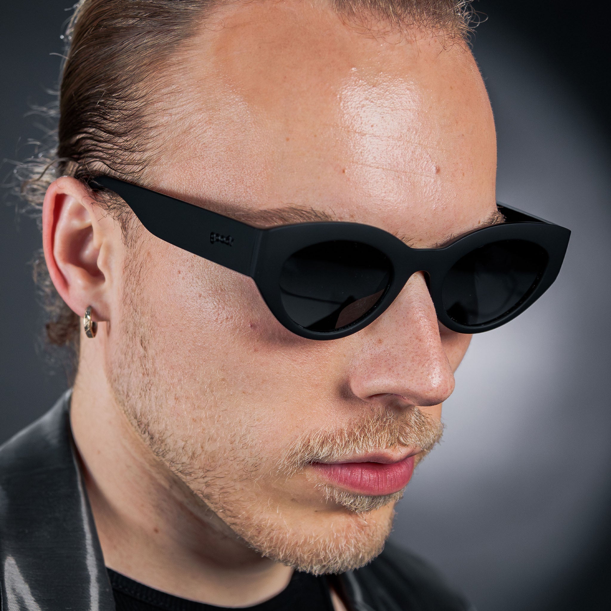 Man Wearing Goodr In My Cosmic Era sunglasses with galaxy-inspired frames, mirrored polarized lenses, and no-slip fit—perfect for bold, active style at Be Charmed.