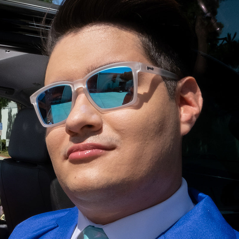 Man Wearing Middle Seat Advantage Goodr sunglasses with sleek polarized lenses, no-slip navy blue frames—perfect for travel; available at Be Charmed