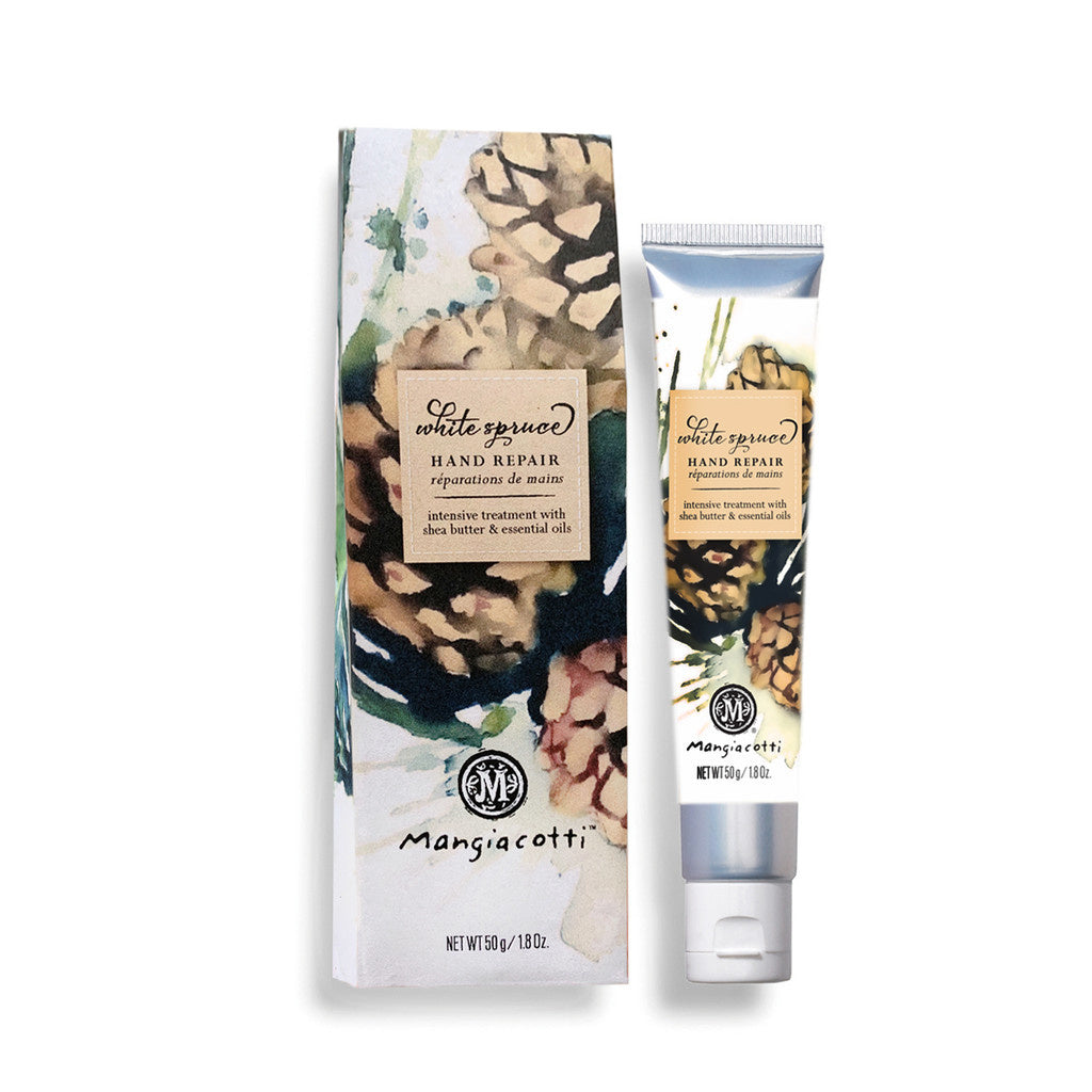Mangiacotti Hand Repair tube and box with White Spruce design, indicating the product soothes and nourishes with chamomile and essential oils. Available at Be Charmed