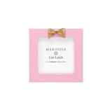 Pink photo frame with gold bow and 'Mariposa' branding on a white background. Available at Be Charmed. 