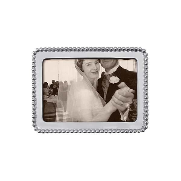 A beaded silver 4x6  Mariposa picture frame, displaying a black and white photo of a couple. Available at Be Charmed