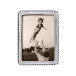 A silver-colored Mariposa beaded picture frame with a 5x7 aspect ratio, displaying a photograph of a child being lifted into the air by an adult. Available at Be Charmed