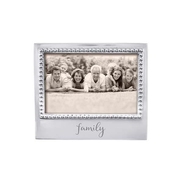 A beaded frame with a family photo, specifically designed to fit a 4 x 6 picture. Available at Be Charmed