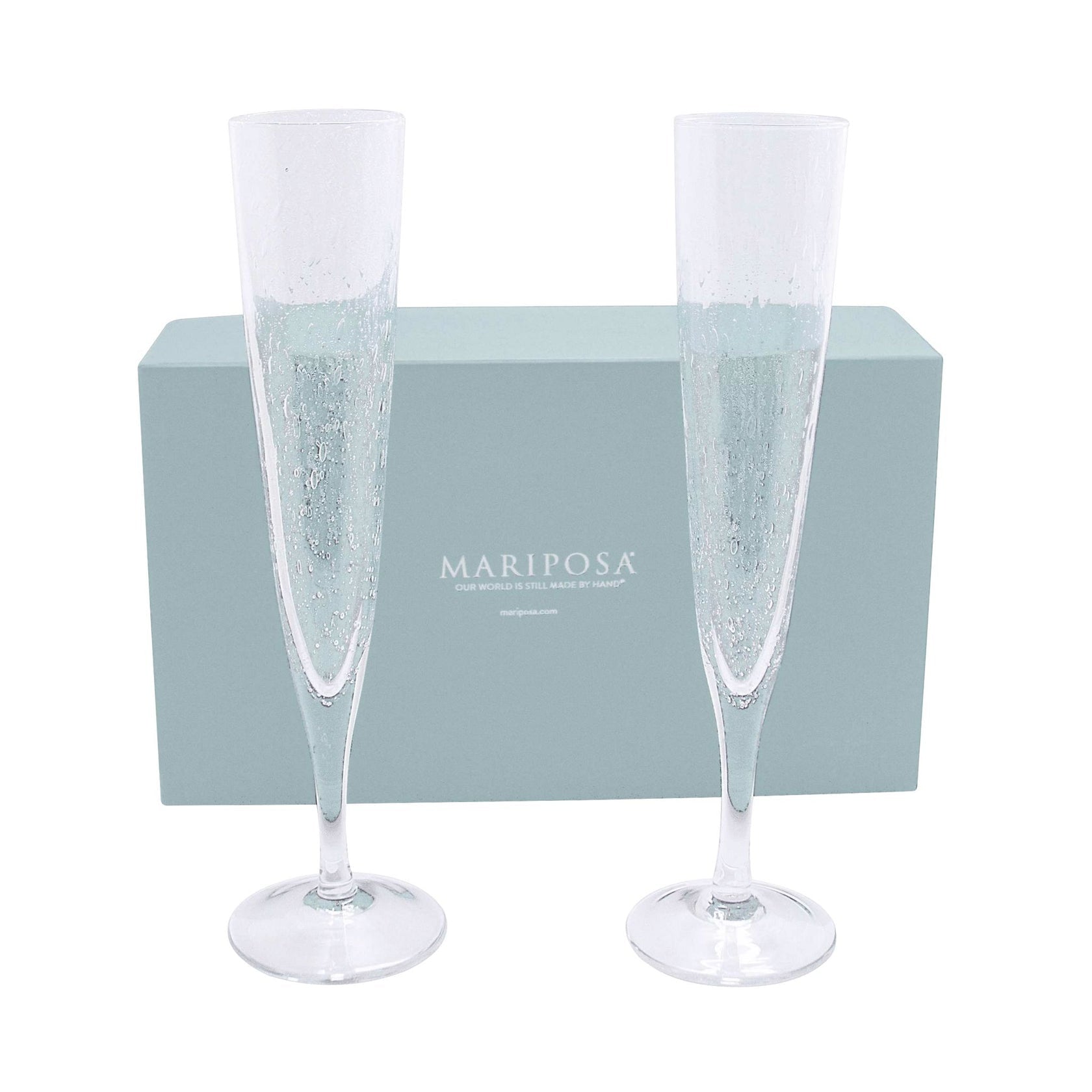 Two clear champagne flutes with a bubbling design, placed on a light blue cushion, with a matching blue box in the background. Available at Be Charmed