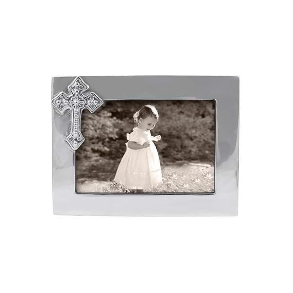A silver picture frame with a cross accent on the side, containing a black and white photo of a child. Available at Be Charmed
