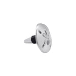 Decorative metal bottle stopper with sand dollar design on a white background. Available at Be Charmed