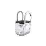 Silver metallic handbag with black interior on a white background. Available at Be Charmed