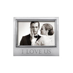 A 4x6 picture frame with a silver border, displaying an image of a couple and the text 'I love us'. Available at Be Charmed