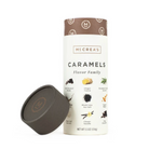 A 5.5oz tube of McCrea's caramel candies with the label showing different flavors such as chocolate, vanilla, birthday cake, and pumpkin spice. Available at Be Charmed