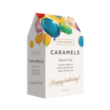 Box of McCrea's Caramels with colorful balloons on a white background. Available at Be Charmed