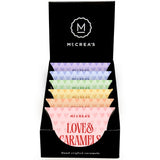 Display box of McCrea's Love & Caramels with colorful candy packages. Available at Be Charmed