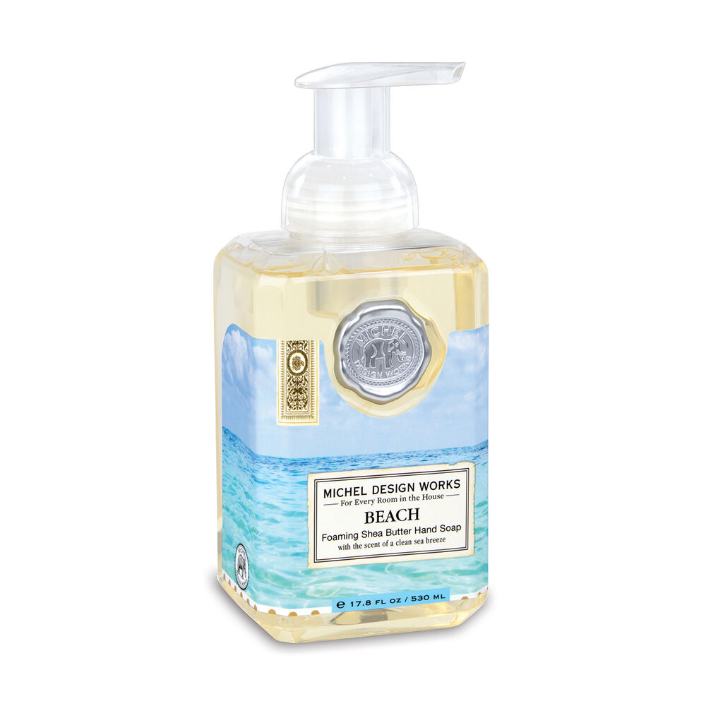Foaming hand soap bottle with beach design label on a white background. Available at Be Charmed