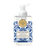 Foaming hand soap bottle with blue and white pattern and gold emblem on a white background. Available at Be Charmed