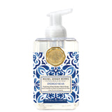 Foaming hand soap bottle with blue and white pattern and gold emblem on a white background. Available at Be Charmed