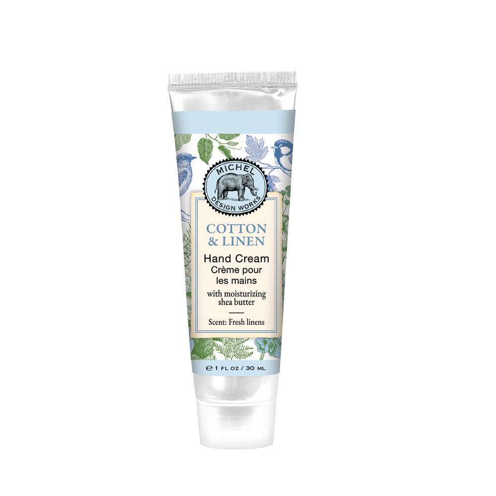 A compact 1 oz travel tube of Cotton Linen Michel Design Works hand cream with vibrant botanical packaging, available at Be Charmed.