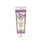A compact 1 oz travel tube of French Lilacs Michel Design Works hand cream with vibrant botanical packaging, available at Be Charmed.