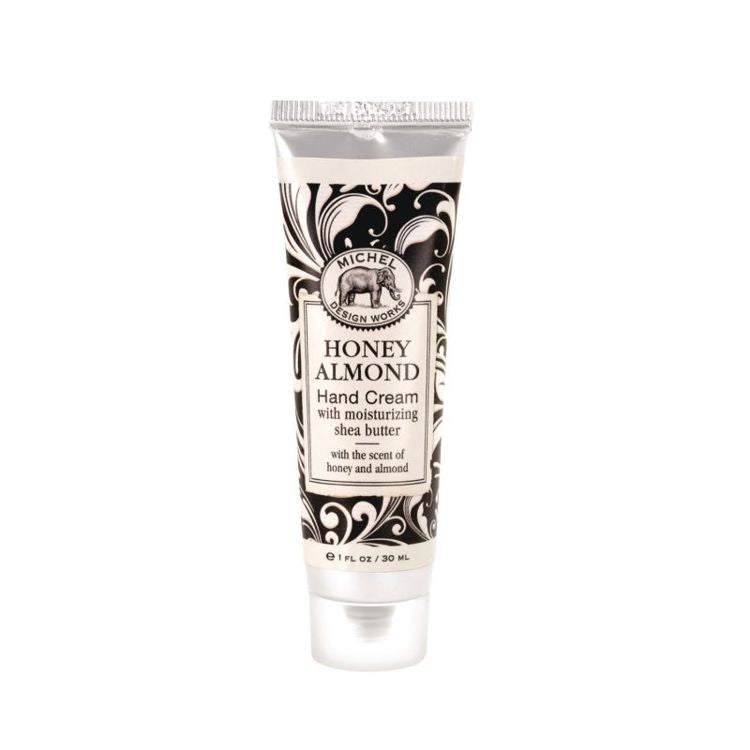 Tube of Honey Almond hand cream with decorative packaging on a white background. Available at Be Charmed